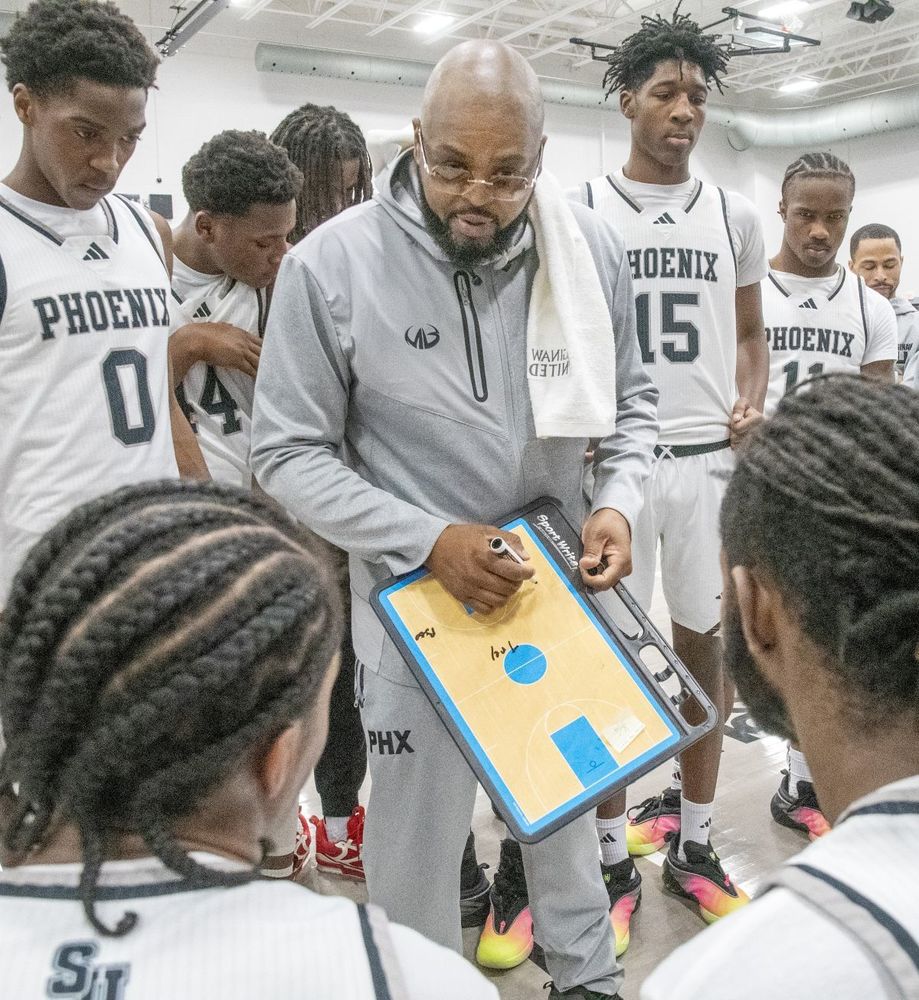Saginaw United basketball team in huddle