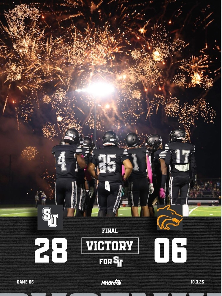 Saginaw United footbal team standing under fireworks