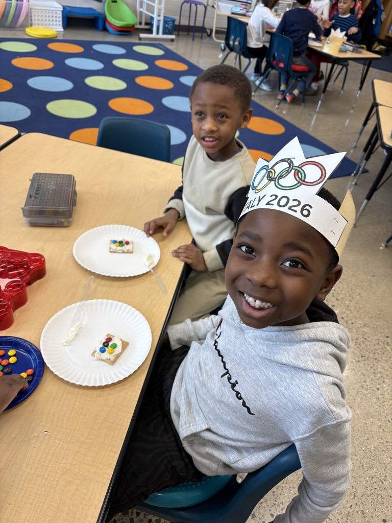 2 students. 1 wearing a paper olympic crown