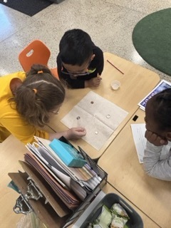 children putting water droplets on change