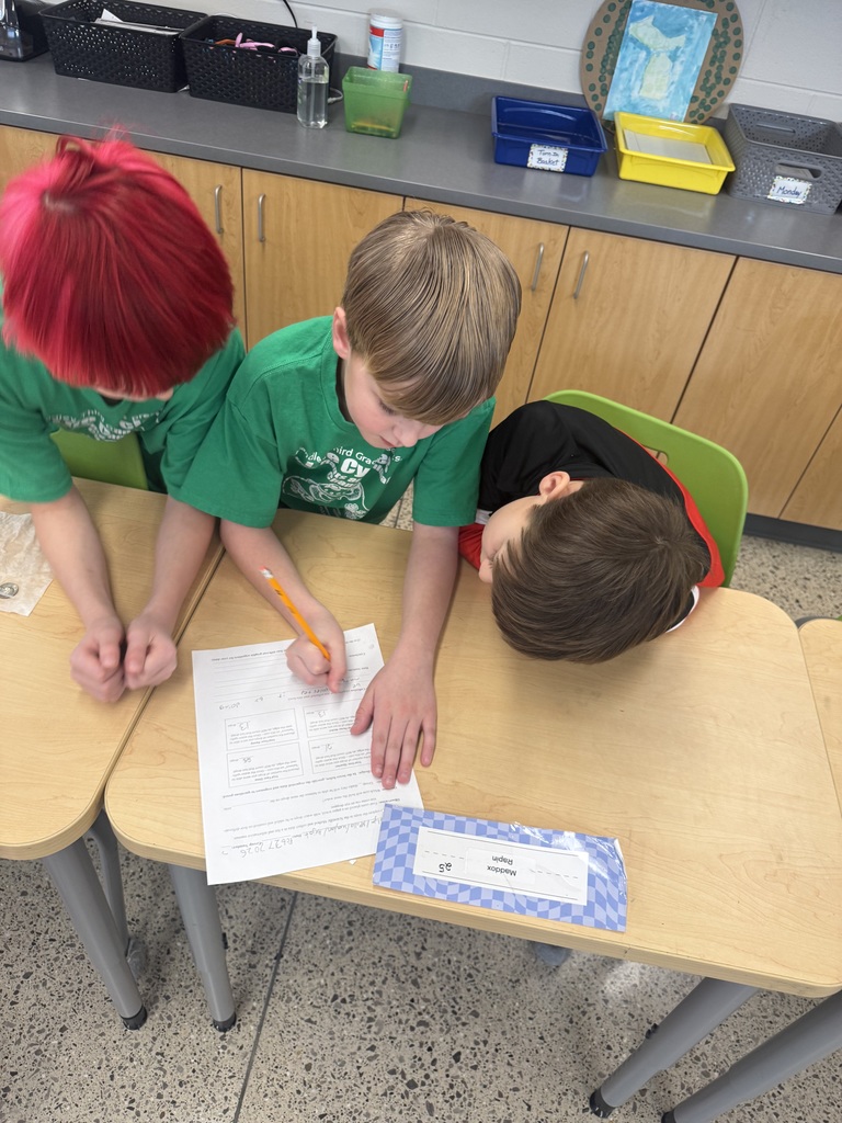 3 children looking at a worksheet