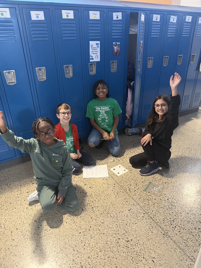students sittting in the hallway by lockers