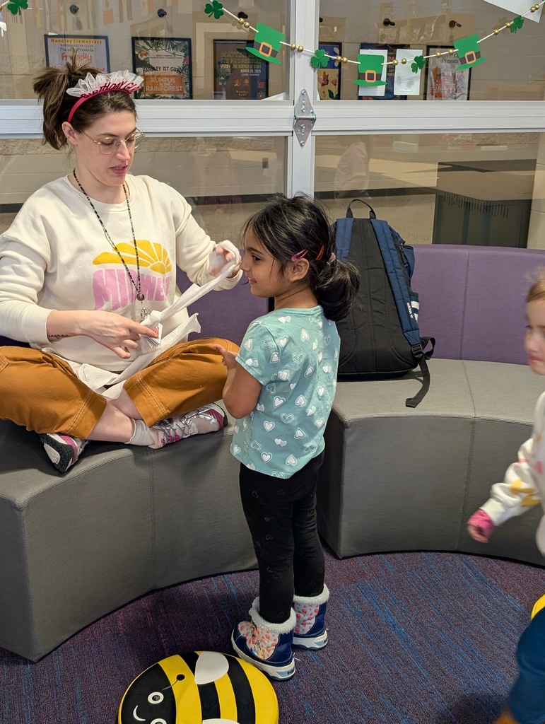 teacher creating a toilet paper headband for a student 