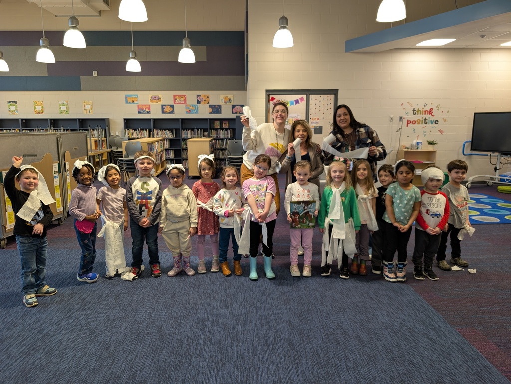 class of students with teachers & librarian standing together wearing toilet paper fashion