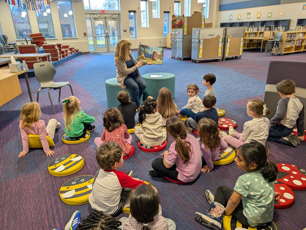 Librarian reading to students the book is "ready set roll"