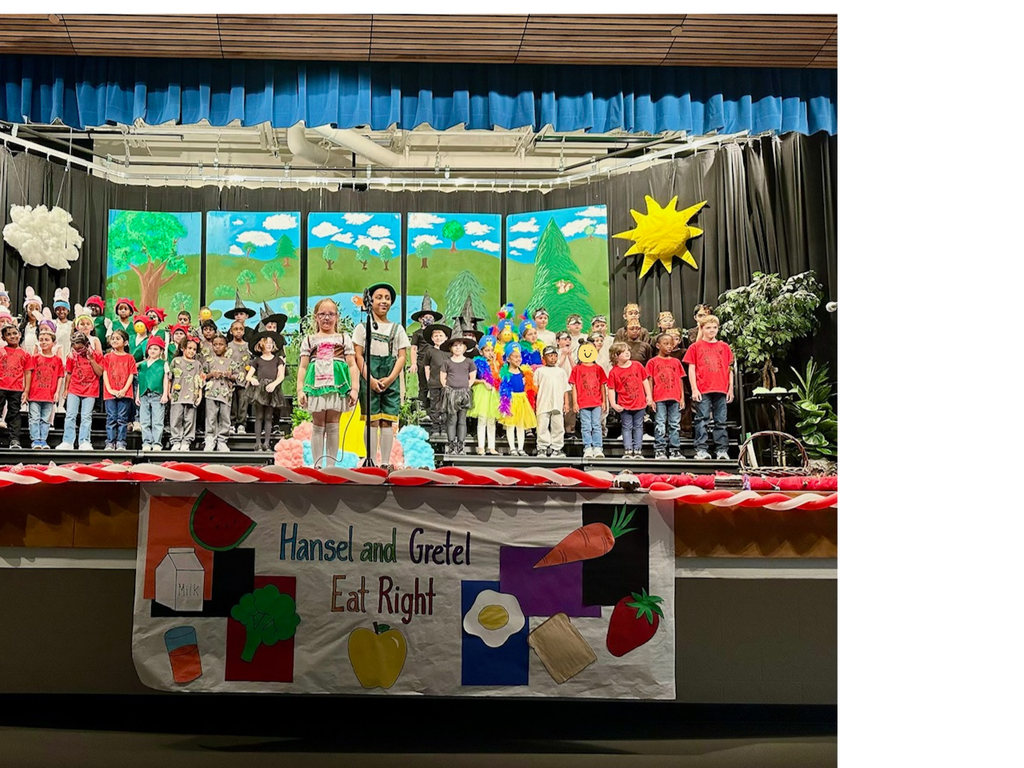 children standing on stage