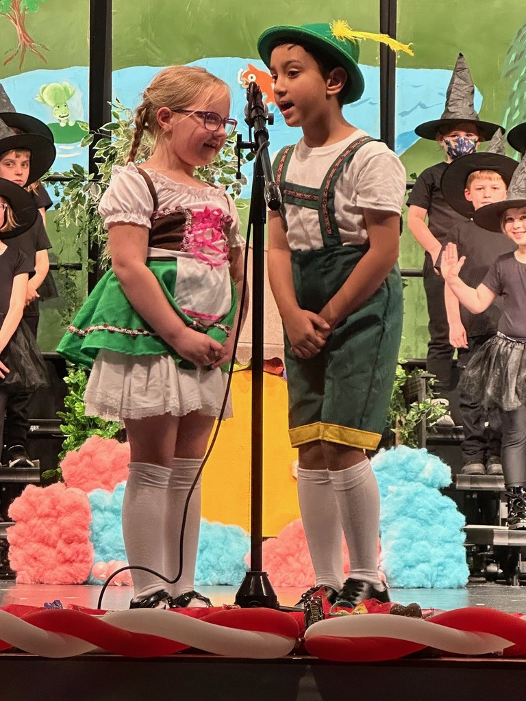 a student in a dirndl & a student in lederhosen