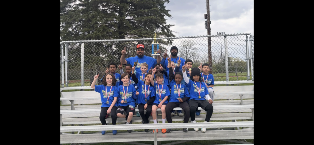13 children holding up their pointer finger for #1 with 2 ocaches also holding the #1 finger up. Holding a trophy