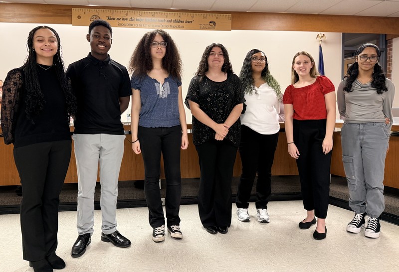 Students posing for a picture in the board room