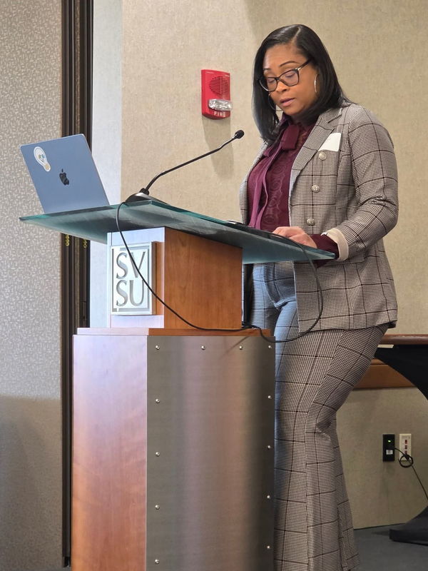 Tiffany Pruitt delivers speech from a podium