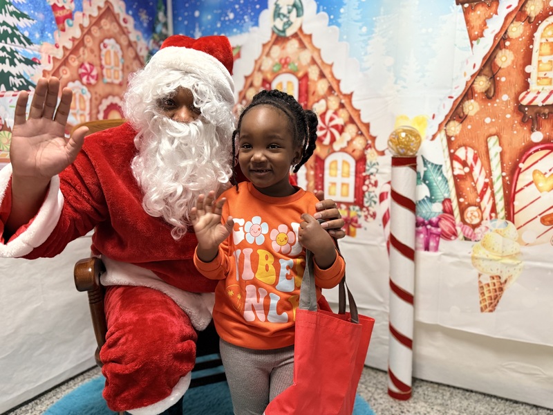 Child posing with Santa Claus