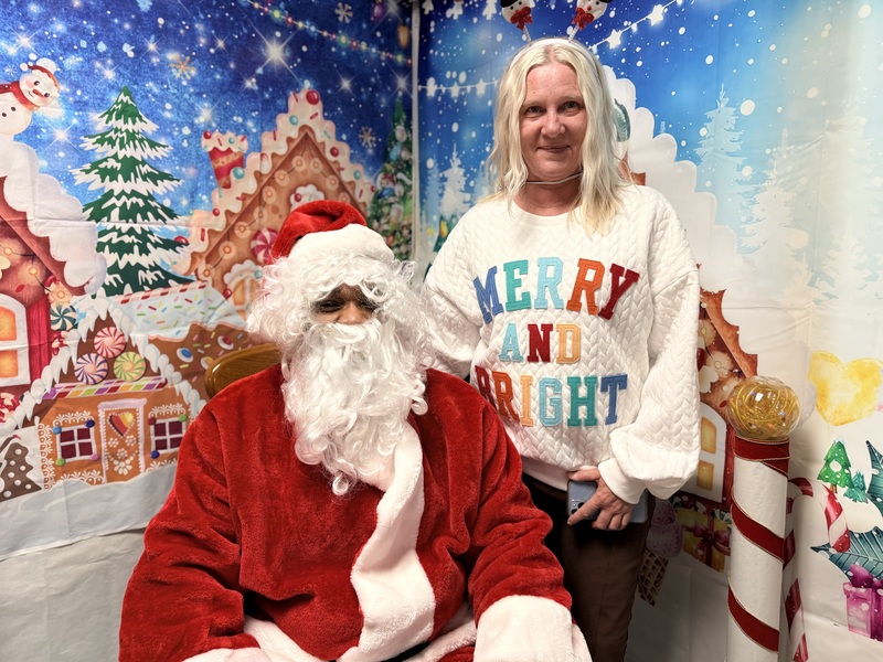 Teacher posing with Santa Claus