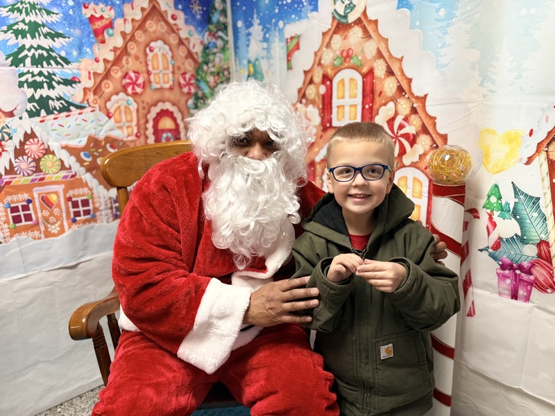 Child posing with Santa Claus