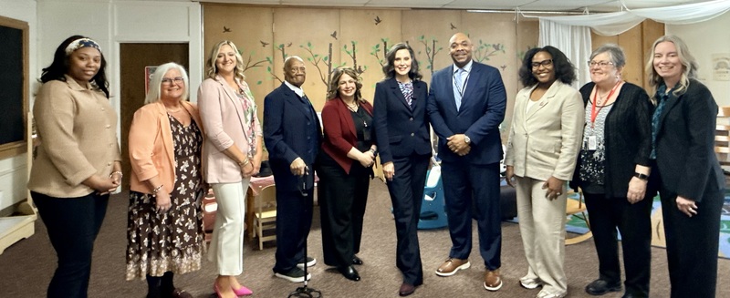 School district officials pose with Gov. Whitmer