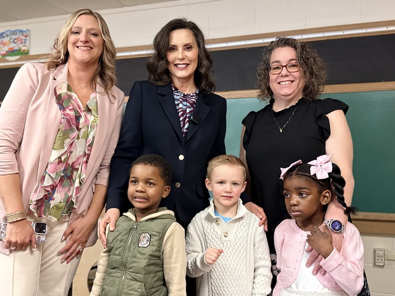 Educators pose with Gov. Whitmer and students