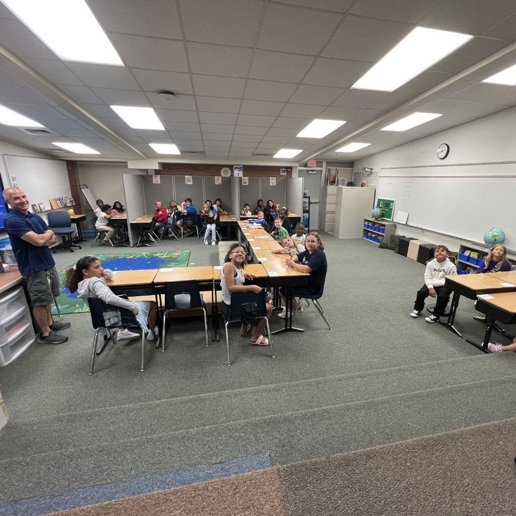 students at desks with teacher
