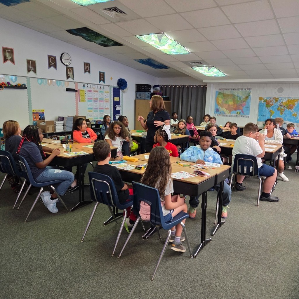 students at desks with teacher