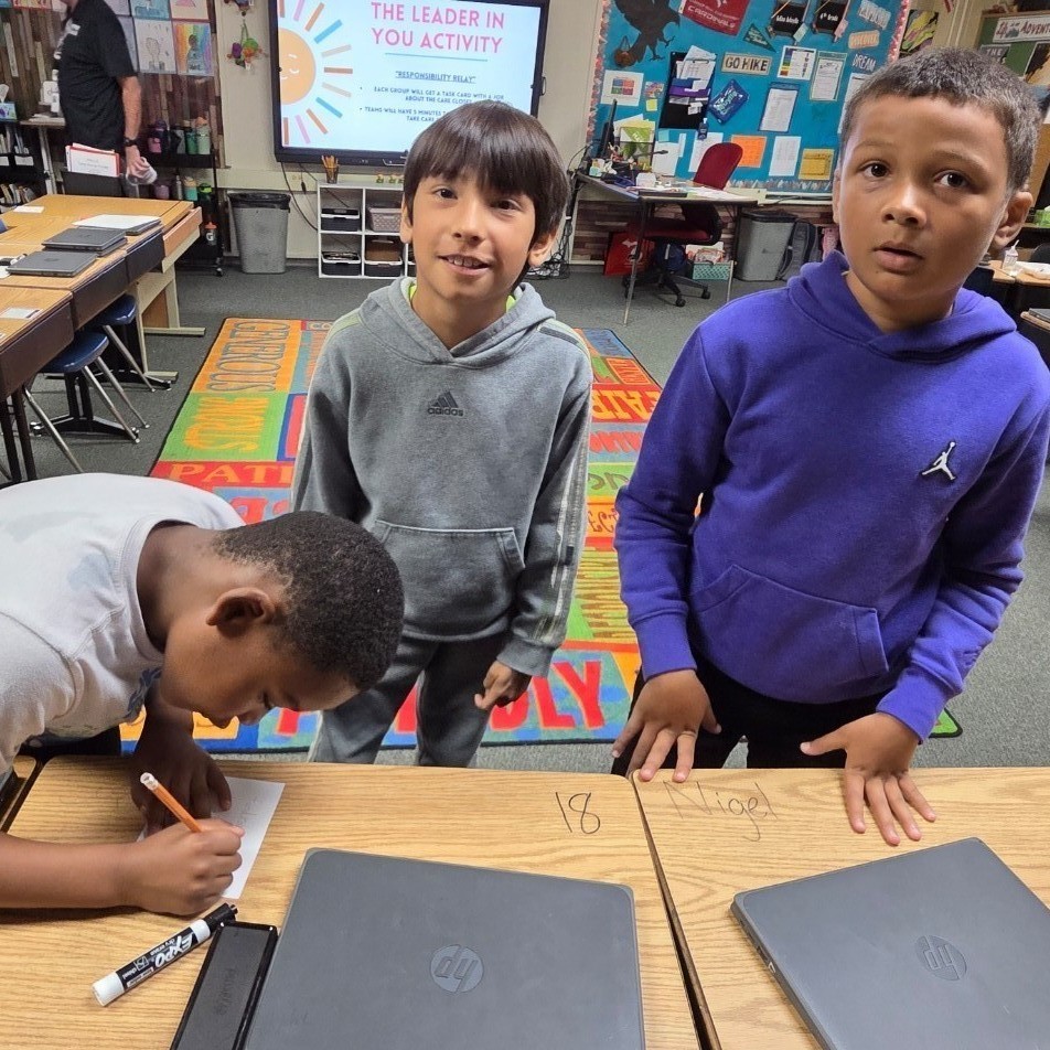 3 boys work on task card