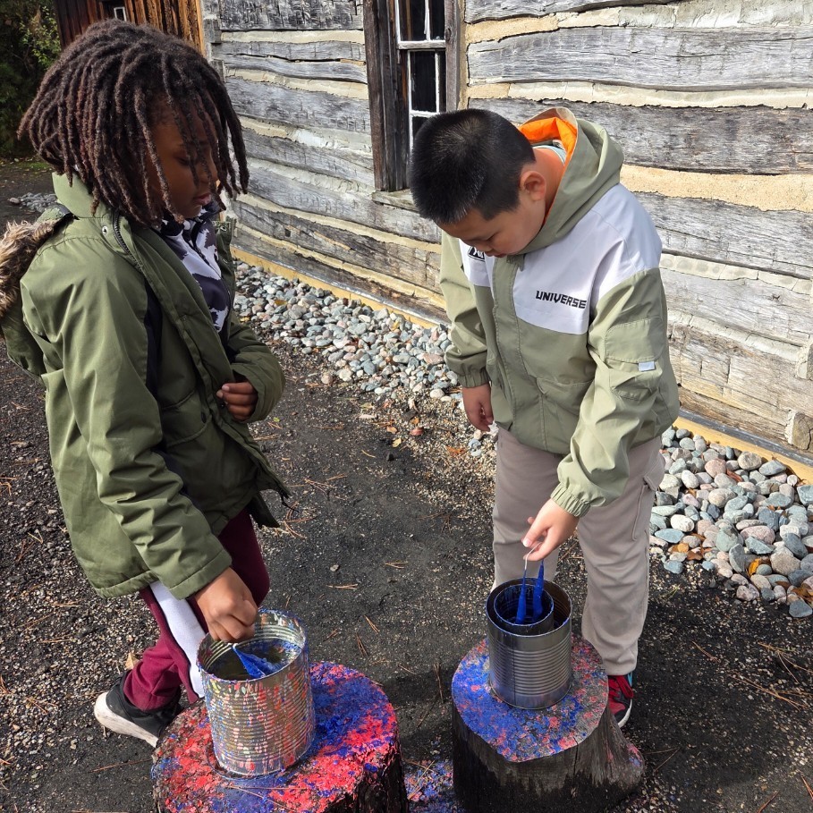two boys dip candles