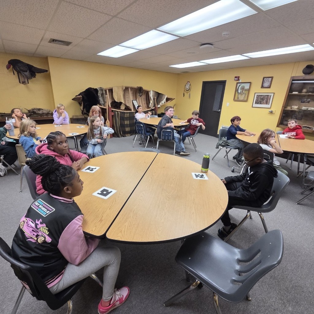 students at round tables