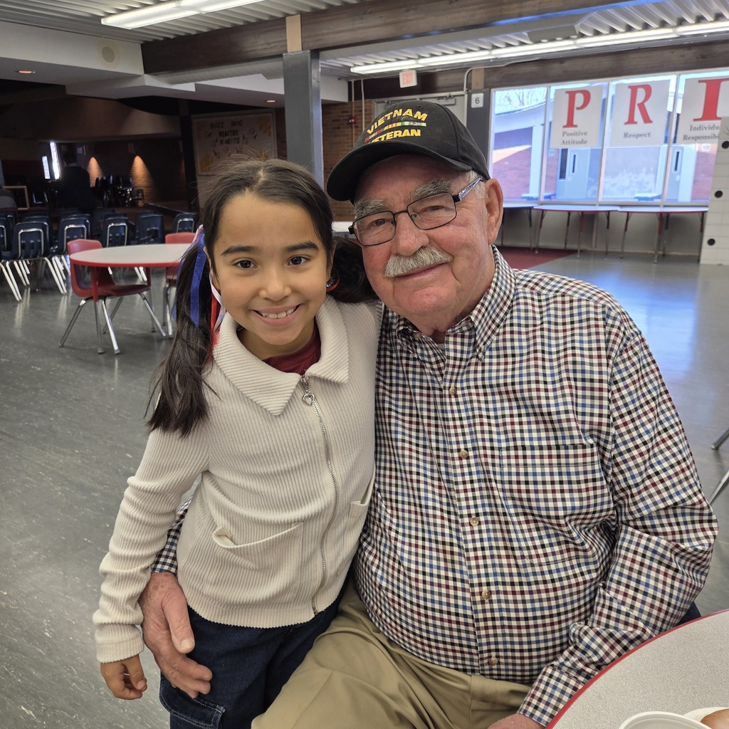 student with grandpa, Vietnam veteran hat