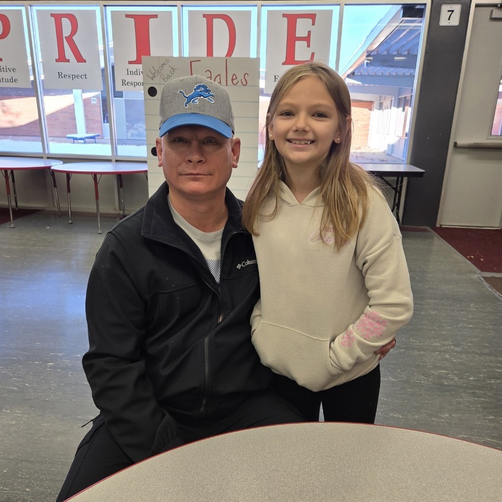 student smiles with dad