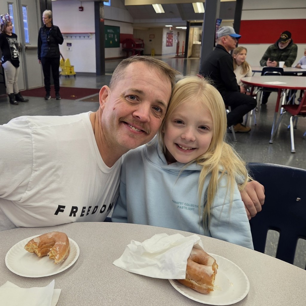 student smiles with her dad