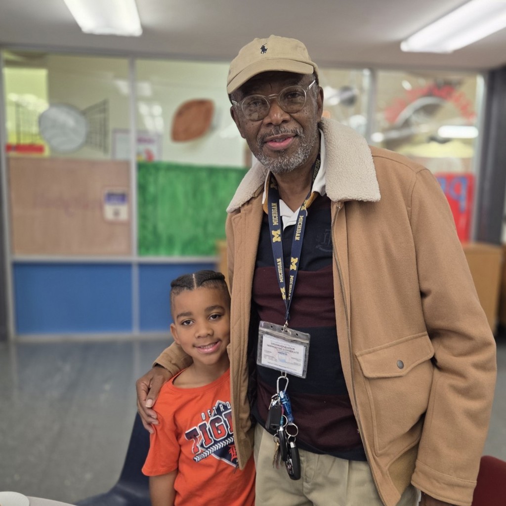 student and veteran stand and smile