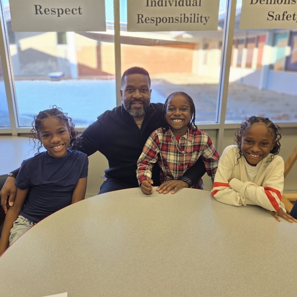 dad and veteran smiles with 3 of his children