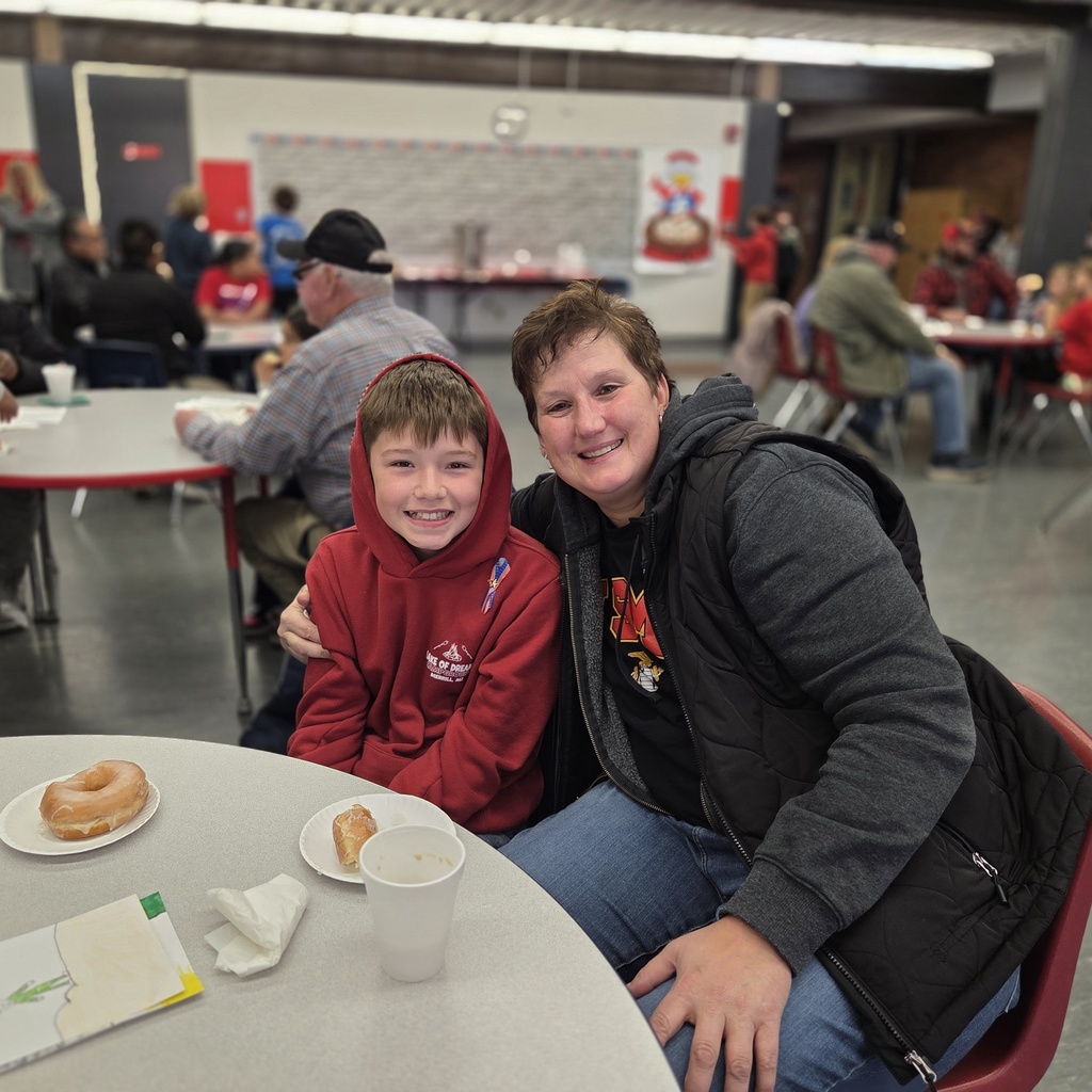 student smiles with their guest 