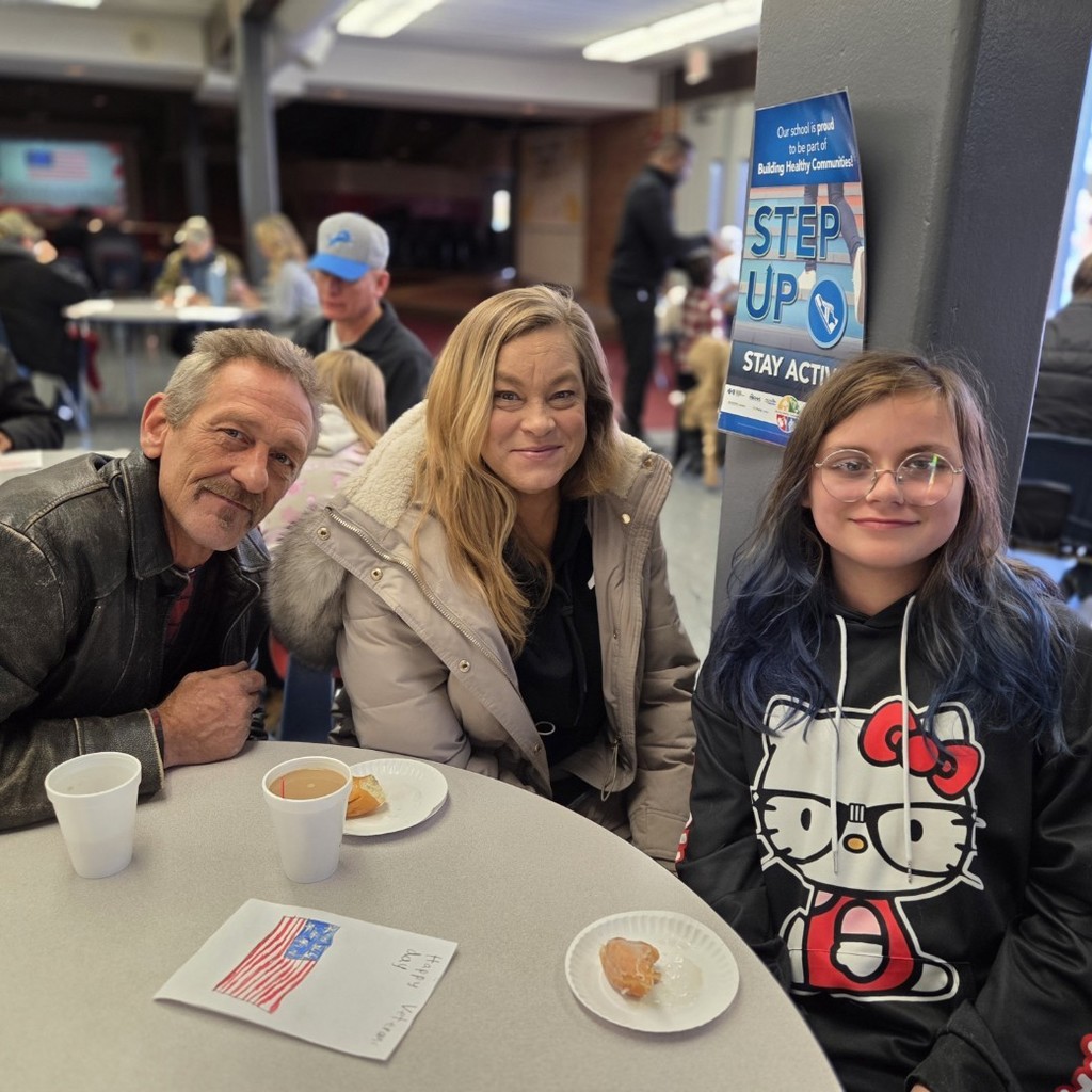 student smiles with her 2 guests