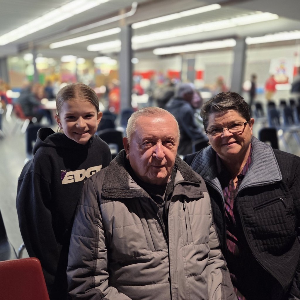 student smiles with grandparents