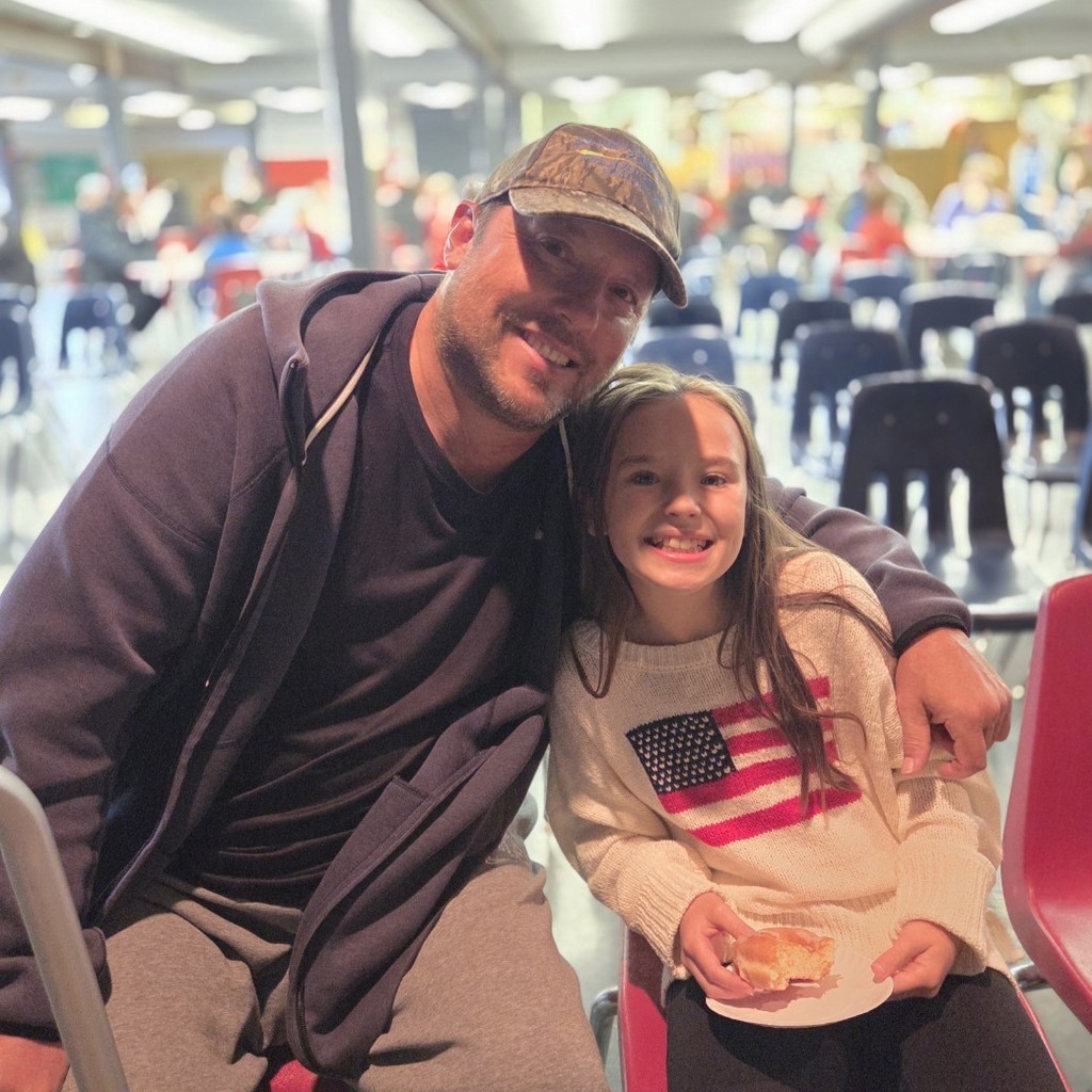 student smiles with guest veteran