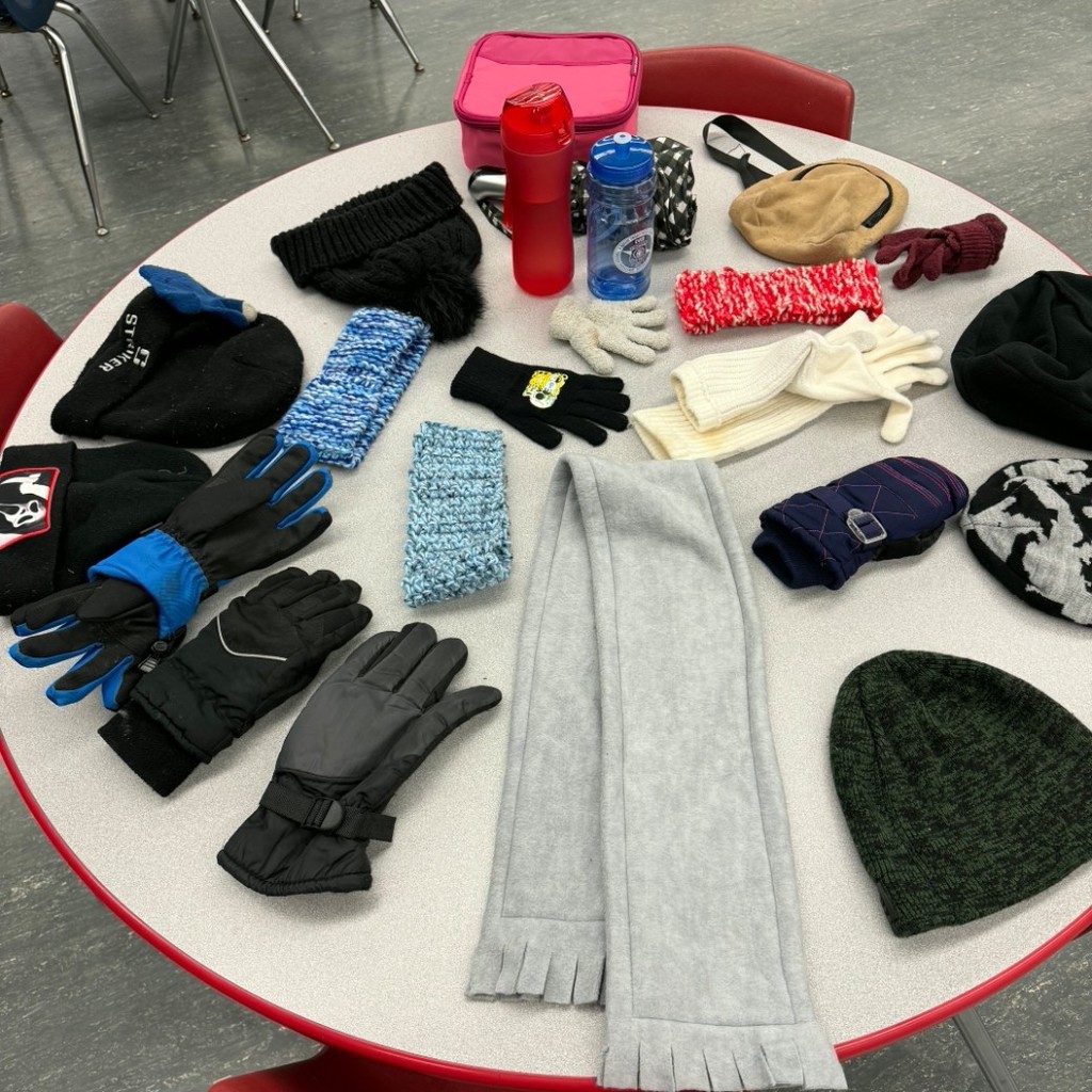table of gloves, water bottles, small items