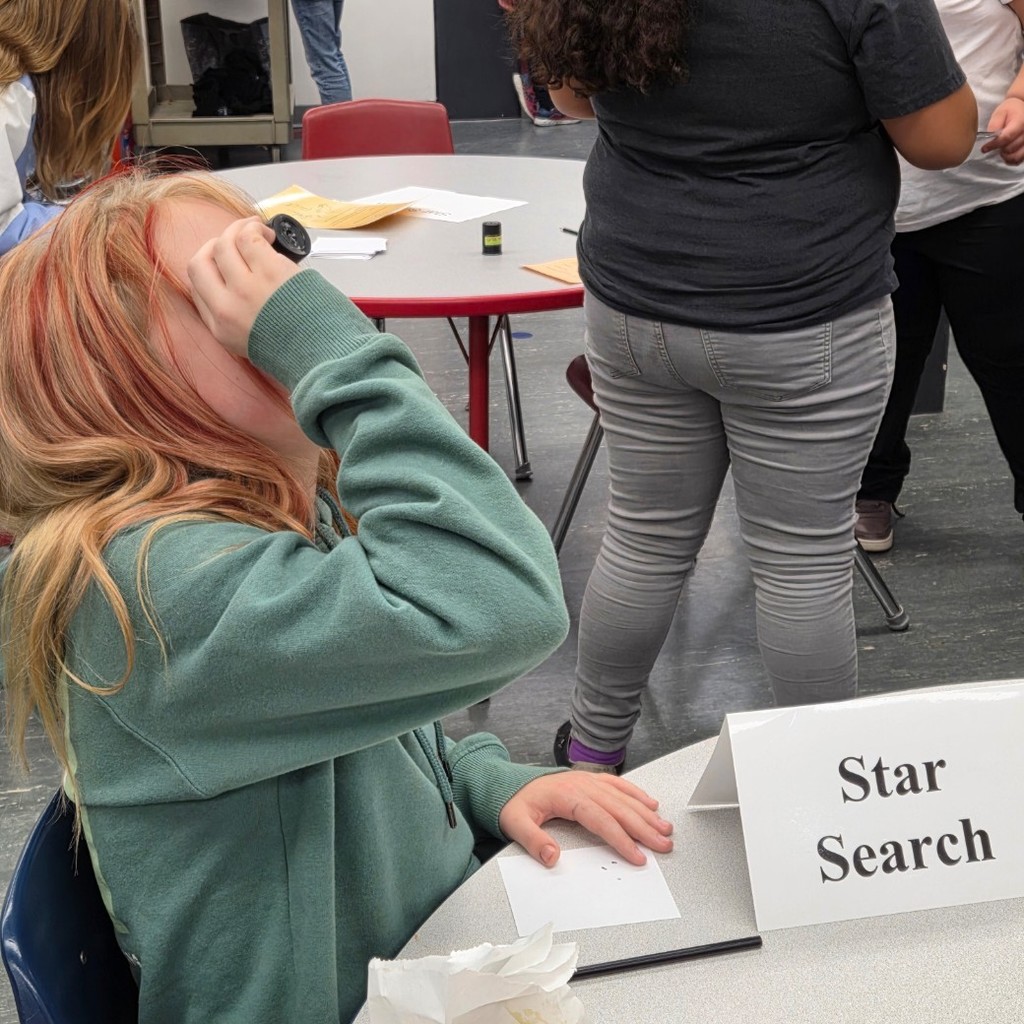 student looks to light at Start Search station
