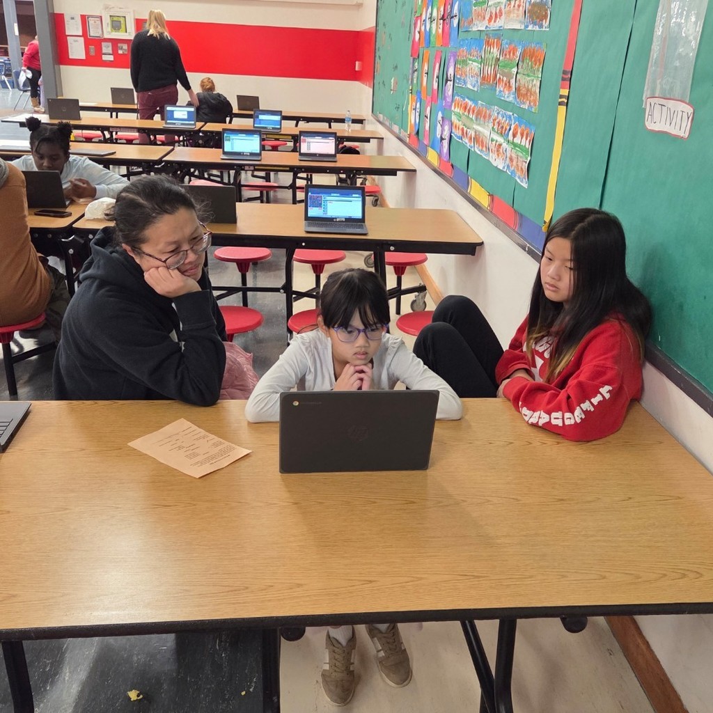 mom and daughters at coding station