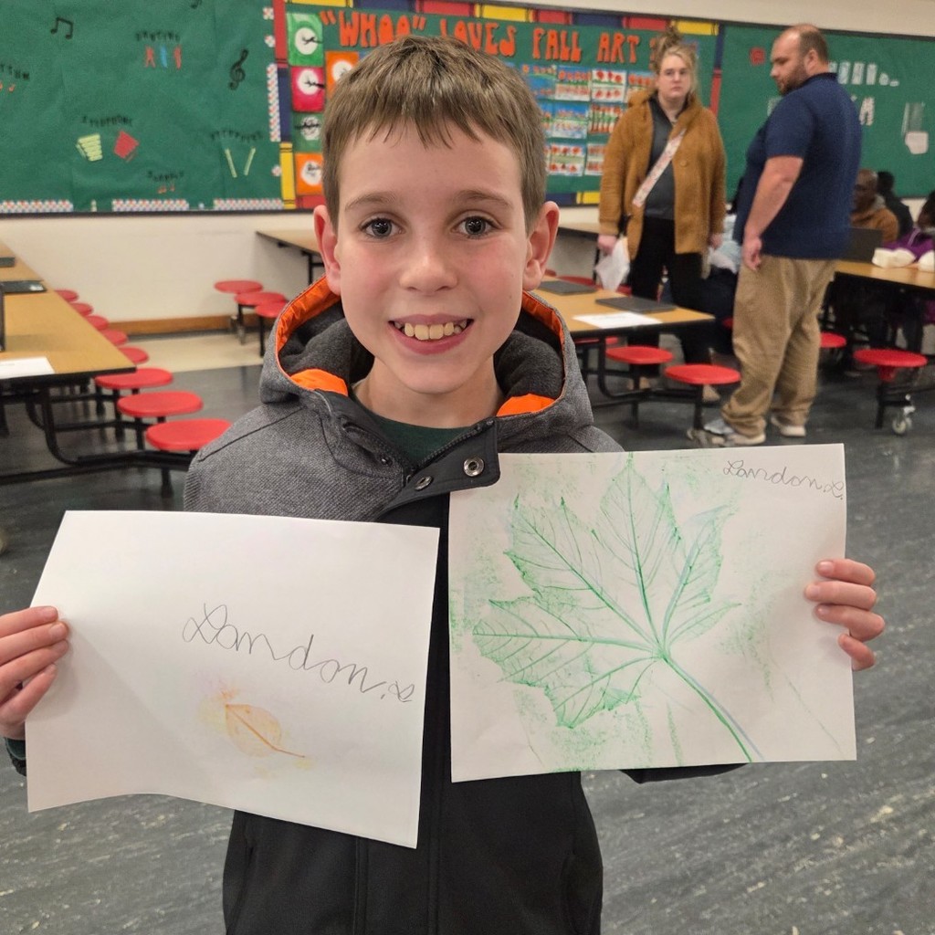 student with leaf rubbings