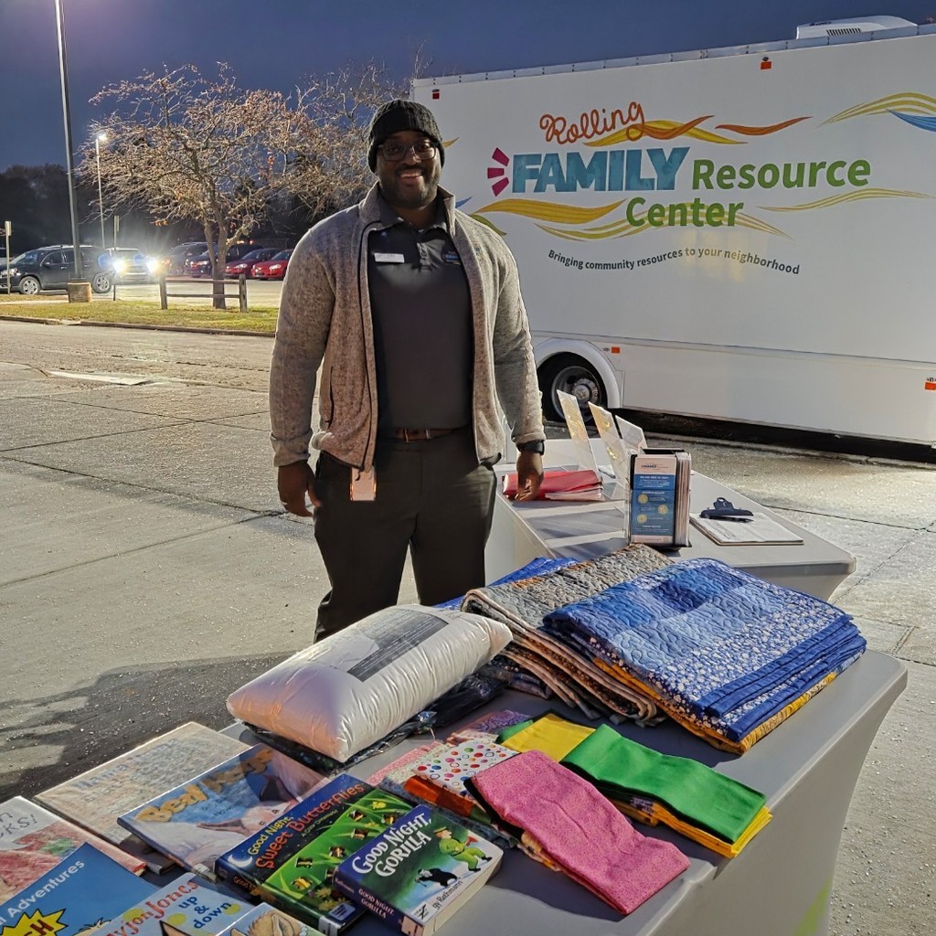 Mr. Grant with resources on table and bus behind