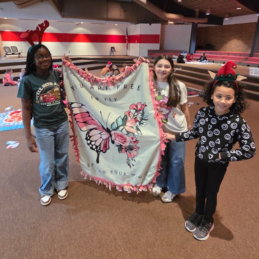 3 5th graders and their finished blanket