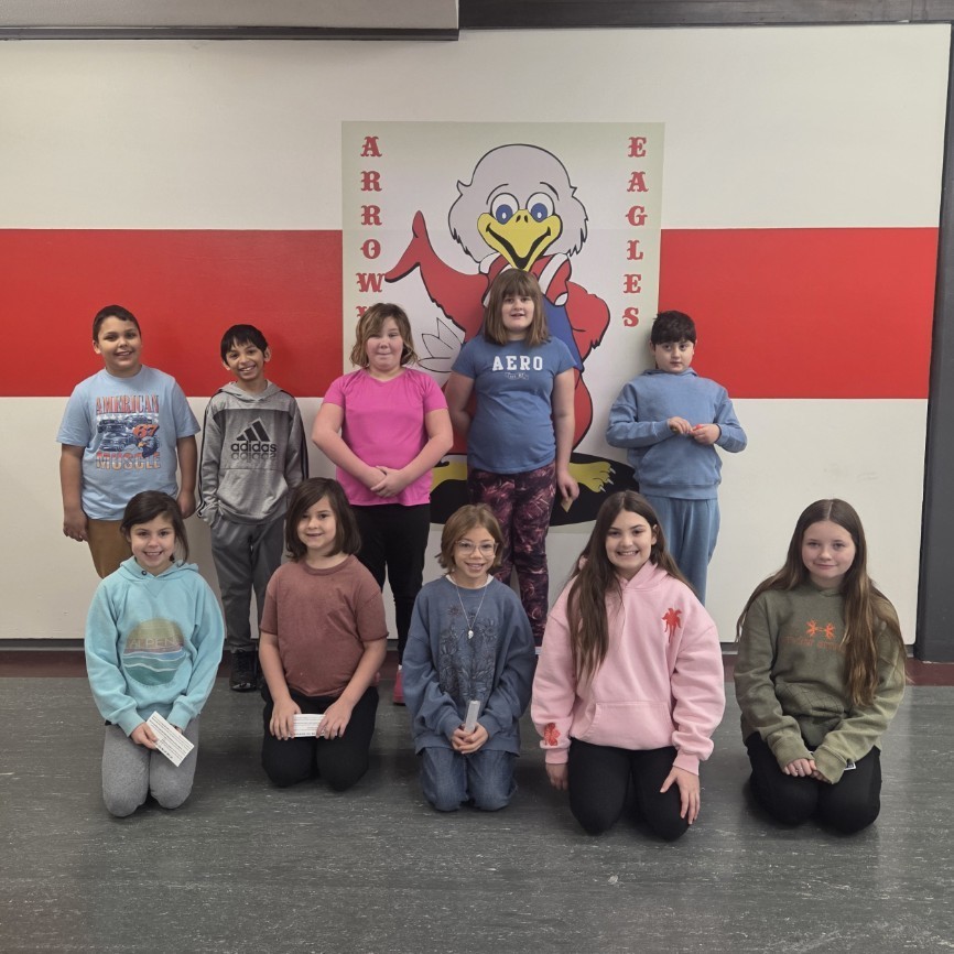 students pose in two rows by mascot