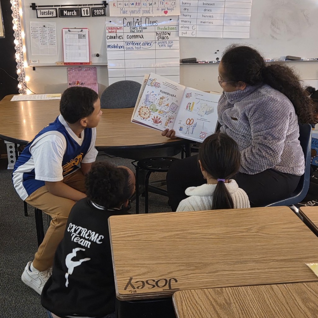 students lean in to look at 