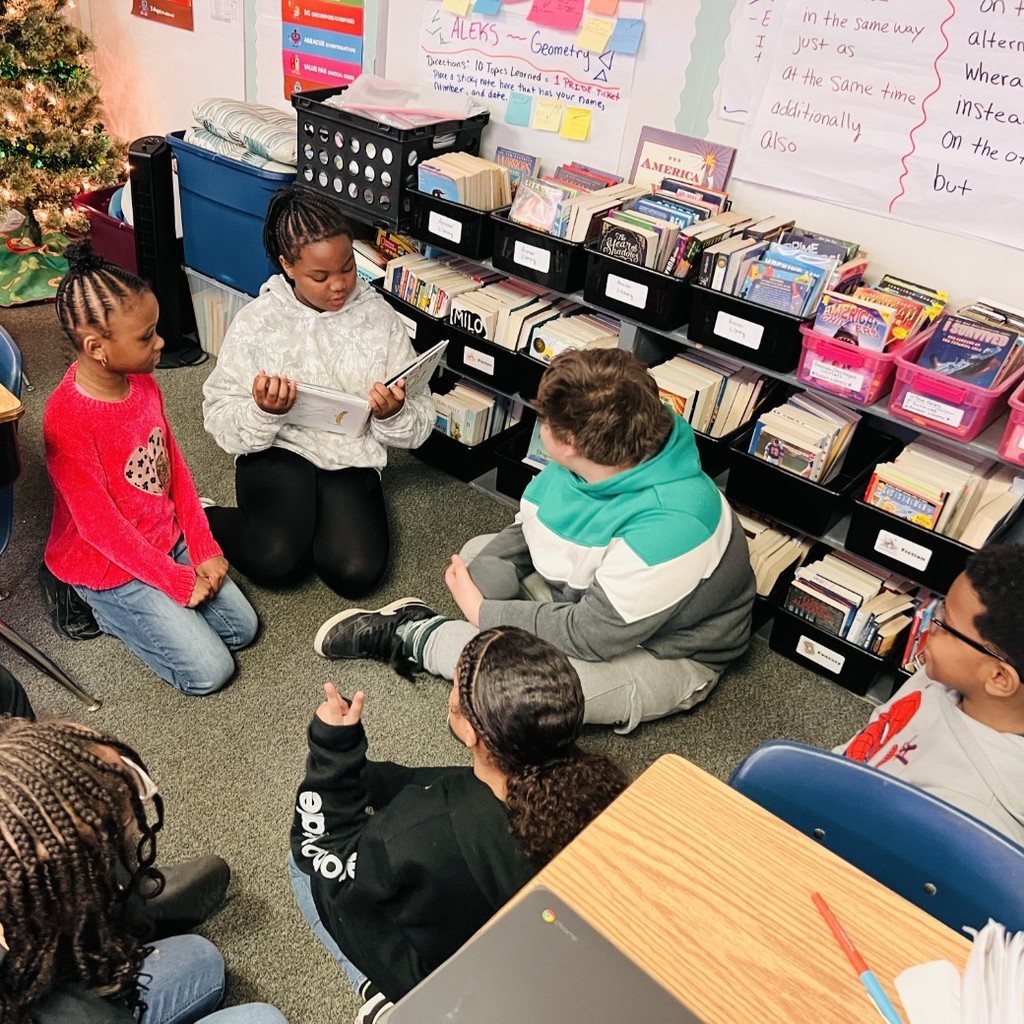 students listen to story read by younger student