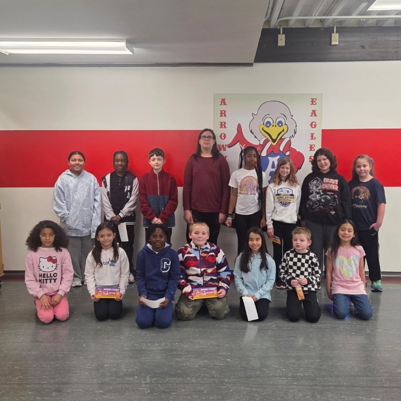 students pose with mascot
