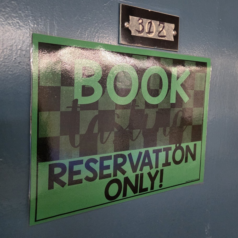 door sign reads Book Tasting: Reservation Only!