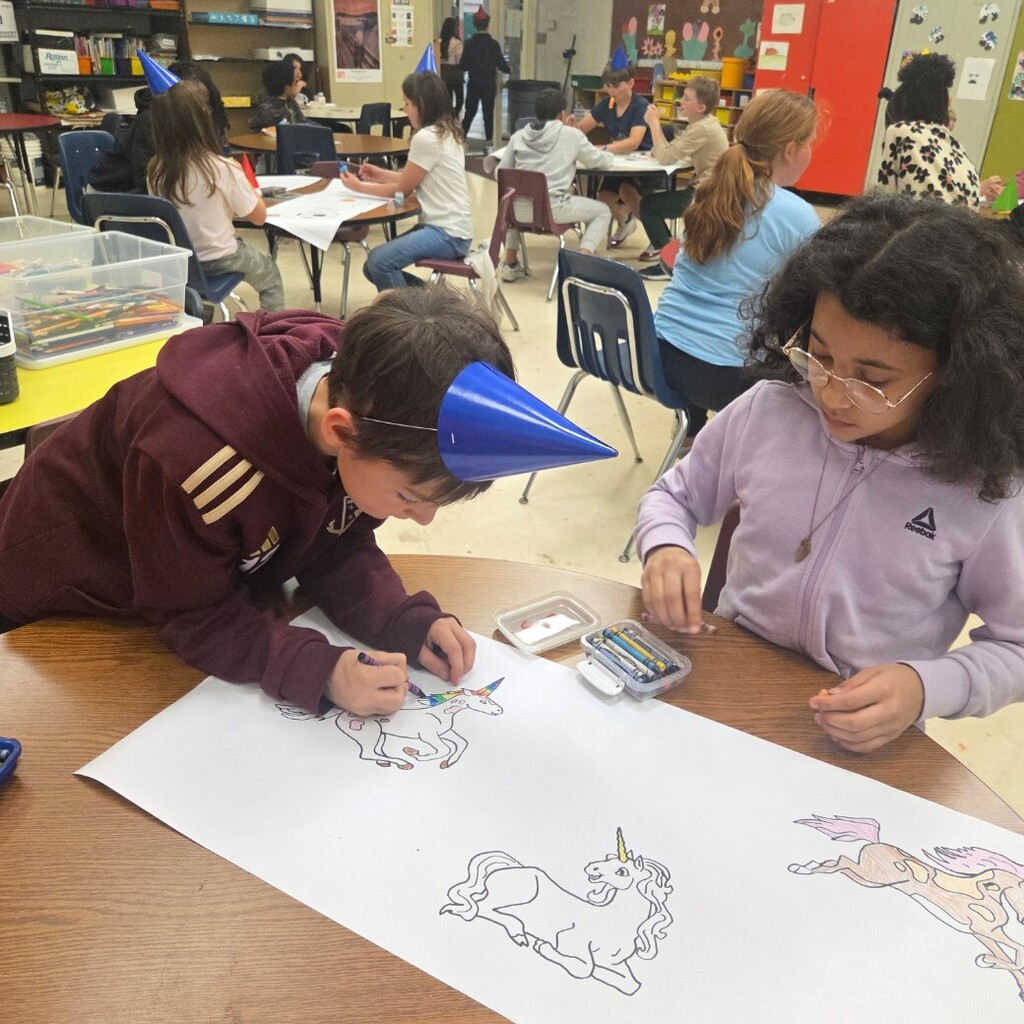 two students color unicorn paper 