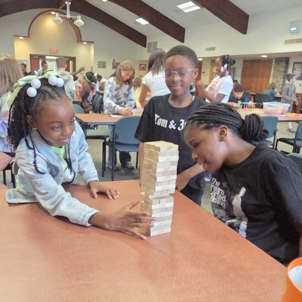 3 students play Jenga