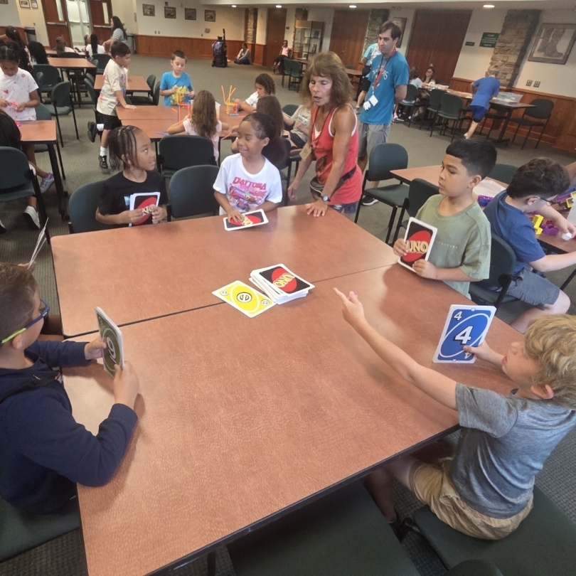 students at table play giant uno