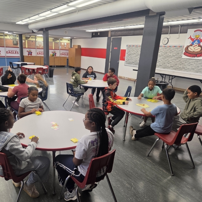 4 tables of kids play games
