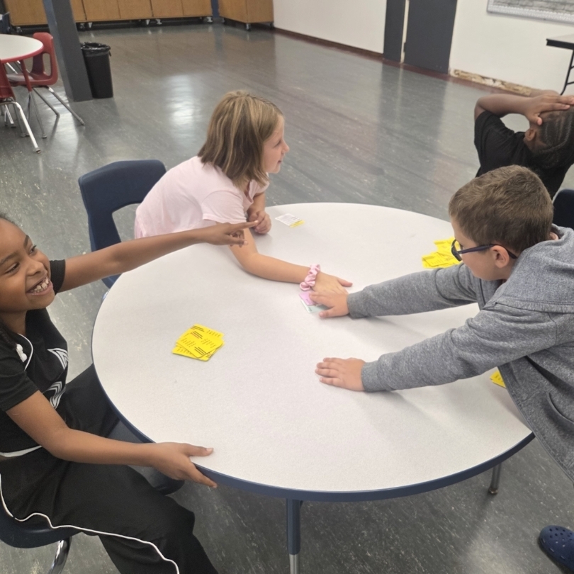 kids slap pile of cards