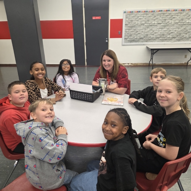 principal with students around the table